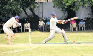 A batsman plays a shot in a match in the All-India Uttarakhand Gold Cup Cricket Tournament played at the Rangers College ground in Dehradun on Friday. 
