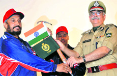 RK Bhatia, Director-General of the ITBP, presents flags to Harbhajan Singh, DIG and team leader of the expedition to Mount Satopanth, in Dehradun on Friday