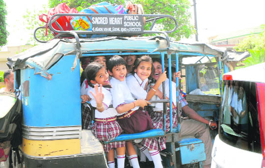  Throwing safety norms to the wind, an autorickshaw driver overloads his vehicle as  he ferries schoolchildren in Jalandhar. 