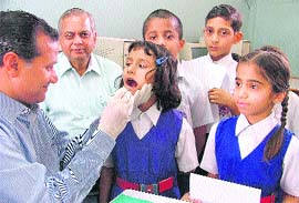 Check-up Students examined in a dental camp at Saraswati Modern School