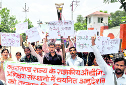Candidates selected as Industrial Training Institute instructors hold a demonstration in Dehradun on Friday