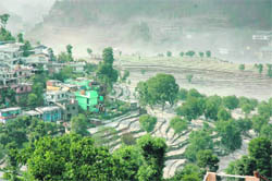 Terraced  fields turned white following a hailstorm in Pithoragarh on Friday.