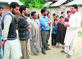 Arshad Ahmed, a candidate for the post of sarpanch, interacts with voters in the Dachnipora block in Anantnag district on Saturday