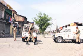 A road closed with barbed wires due to prohibitory orders in Srinagar on Saturday