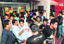 Protesting viewers queue up to get their money back at a ticket counter of Fun Republic at Mani Majra in Chandigarh on Sunday.