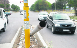 A broken streetlight pole at the Punjab Mandi Board Housing Complex traffic junction at Sector 67, Mohali, poses a threat to motorists
