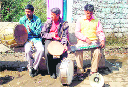   Madan Lal (right), with members of his Garhwali band, plays his keyboard at a wedding.  