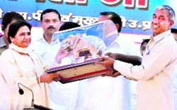 Uttar Pradesh Chief Minister and BSP chief Mayawati receives a gold elephant replica at a party rally in Haridwar on Sunday.