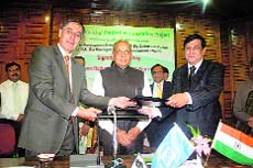 Sudripto Roy, Addl Chief Secy (Forests) for the state, Hubert Nove Josserand, Deputy Country Director for the World Bank, in the presence of CM PK Dhumal in Shimla on Sunday.