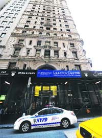 A police car is parked outside the building where former IMF chief Dominique Strauss-Kahn is being held under house arrest in New York