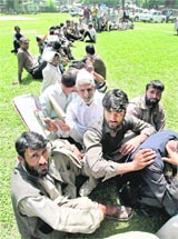 People wait to meet Chief Minister Omar Abdullah outside his private office in Srinagar recently.