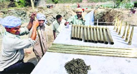 Workers prepare the venue at the site of Basohli bridge in Jammu on Sunday.