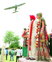 A small plane drops paper petals at a marriage venue in Kaind village on Sunday