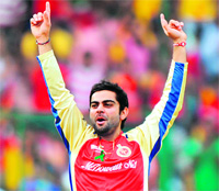 Royal Challengers Bangalores Virat Kohli celebrates the wicket of Chennai Super Kings Wriddhiman Saha at the M. Chinnaswamy Stadium in Bangalore on Sunday. RCB won the match by 8 wickets