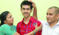 Ghaziabads topper: Divyansh Sharma being greeted by his parents as he secured 98.6 per cent in CBSE Class XII exams in Ghaziabad.