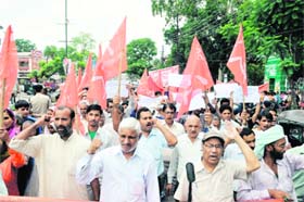 Workers of the CPM hold a march in Dehradun on Monday