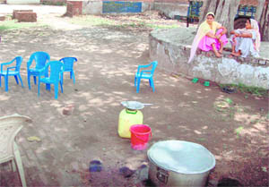 Workers and cooked food await children at the anganwari centre in Panjokra village of Ambala in Haryana.