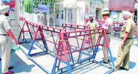 Cops guard the gate of the PSPCLs headquarters in Patiala on Monday.