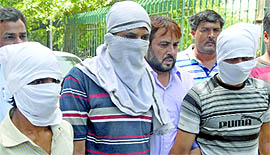 Rahul, Mahender and Satish, involved in Muthoot Finance Ltd robbery case, at PHQ in New Delhi on Tuesday.