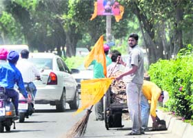 CLEANING ACT MC workers clean the Pakhowal road ahead of Akali leader Bikramjit Singh Majithia’s visit to Ludhiana on Tuesday