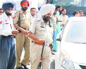 Policeman recovers a baseball bat that was used to smash the windscreen of a bus in Ludhiana on Tuesday