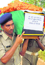 Cops carry a coffin of their colleague, who was killed in Maoist ambush, in Raipur on Tuesday