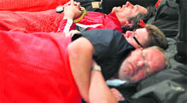 Passengers sleep on the floor at the Edinburgh Airport, Scotland