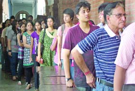 Students and parents queue up at St. Stephens College to purchase admission forms on the first day of their sale in New Delhi on Wednesday