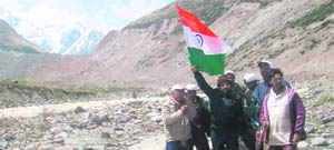 Tarun Vijay, BJP Rajya Sabha MP, holds the National Flag during the "Seema Darshan Yatra" near the Milam glacier in Pithoragarh district.