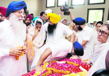 Deputy Chief Minister Sukhbir Badal leans over the body of his mother Surinder Kaur in Badal village on Wednesday. CM Parkash Singh Badal and his daughter Preneet Kaur can also be seen. 