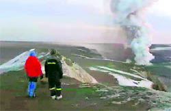 People watch a plume rising from the Grimsvotn volcano in Iceland on Wednesday