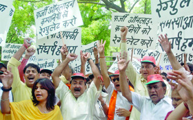 BJP activists shout slogans during a demonstration against the UPA government, demonding a ban on the fraud online companies, at Jantar Mantar in New Delhi on Thursday. 