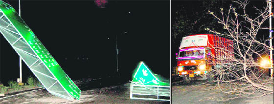 A sign board that was broken in the high-velocity storm at Rishikul Road in Haridwar; and (right) a tree fallen on the national highway owing to a heavy storm and rain in Haridwar on Wednesday.