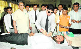 RS Baswana, district and sessions judge, Kaithal, affixes a badge on a donor during a blood donation camp organised by the District Bar Association in Kaithal.