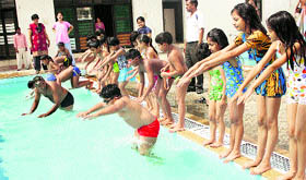 Children learn swimming during a summer camp organised by Delhi Public School in Rohtak.