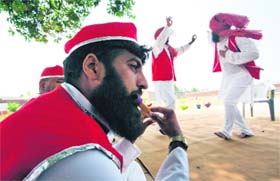 Atta Mohammed, 34, who is serving a life term, plays a flute during a routine dance and music practice in the Kotbhalwal central jail in Jammu on Thursday