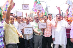 Activists of the Bharatiya Janata Yuva Morcha stage a protest outside Raj Bhawan in Jammu on Thursday against the decision of Shri Amarnathji Shrine Board to curtail the Amarnath yatra by 15 days