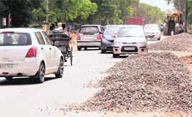 strewn Concrete and gravel dumped along a road affects the movement of vehicles in
