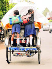MIRTHFUL Children enjoying a light drizzle on way to their school in Chandigarh on Friday morning.