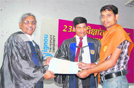 Prof SK Singh (left) Vice-Chancellor, Hemwati Nandan Bahuguna Garhwal University, gives the degree certificate to a student at the convocation of Indira Gandhi National Open University in Dehradun on Friday