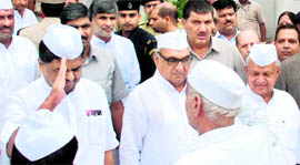 BK Hari Parsad, AICC General Secretary (left), takes the salute from Congress Seva Dal workers during a mahasammelan organised by the Haryana Pradesh Congress Committee (HPCC) at Panchkula on Friday as Chief Minister Bhupinder Singh Hooda (centre) and State party chief Phool Chand Mullana (extreme right) look on.