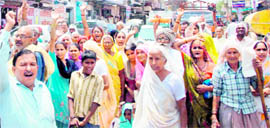 Old-age pensioners block traffic in Faridabad on Friday.