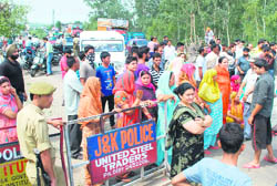 Residents of the Gadigarh area stage a protest in Jammu on Friday