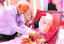 A Congress worker pays tributes to Pandit Jawaharlal Nehru on his death anniversary in Ludhiana on Friday. 