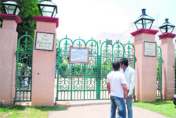 Youngsters read a notice put up on the main gate of the hotel where the shooting of a Salman Khan-starrer movie will take place.