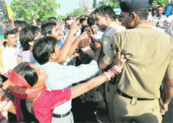Police personnel being pushed by residents of Colony No 4 during the protest in the Industrial Area, Chandigarh, on Saturday