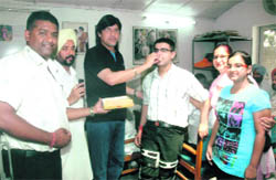 CPS Harish Rai Dhanda offers sweets to Rahul Duggal for his achievement in Ludhiana on Saturday. 