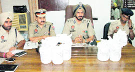 Police officials show the seized contraband in Abohar on Saturday.
