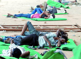 Labourers during a lunch break at Ramlila Grounds on a hot summer day in New Delhi on Sunday.