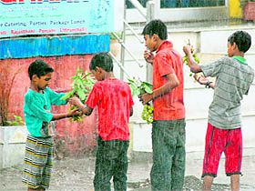 A group of boys savour litchis plucked from a garden in rain in Dehradun on Sunday.